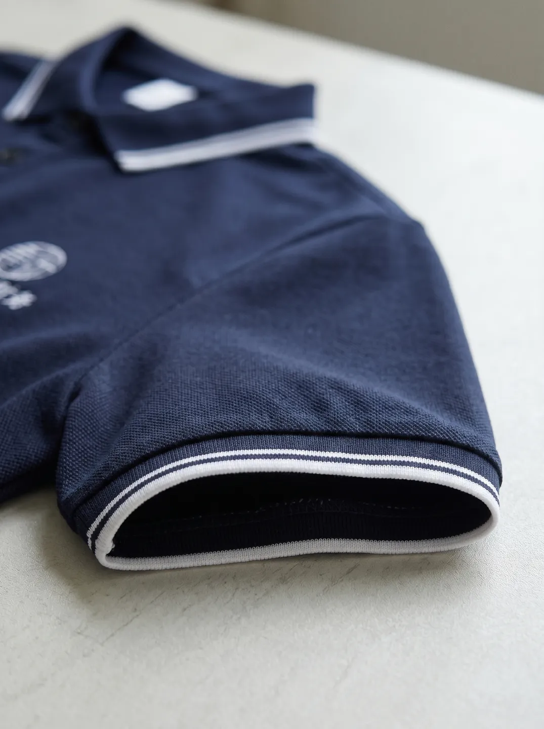 Navy Polo Shirt · Logo and design details · PM-C-075 / 5