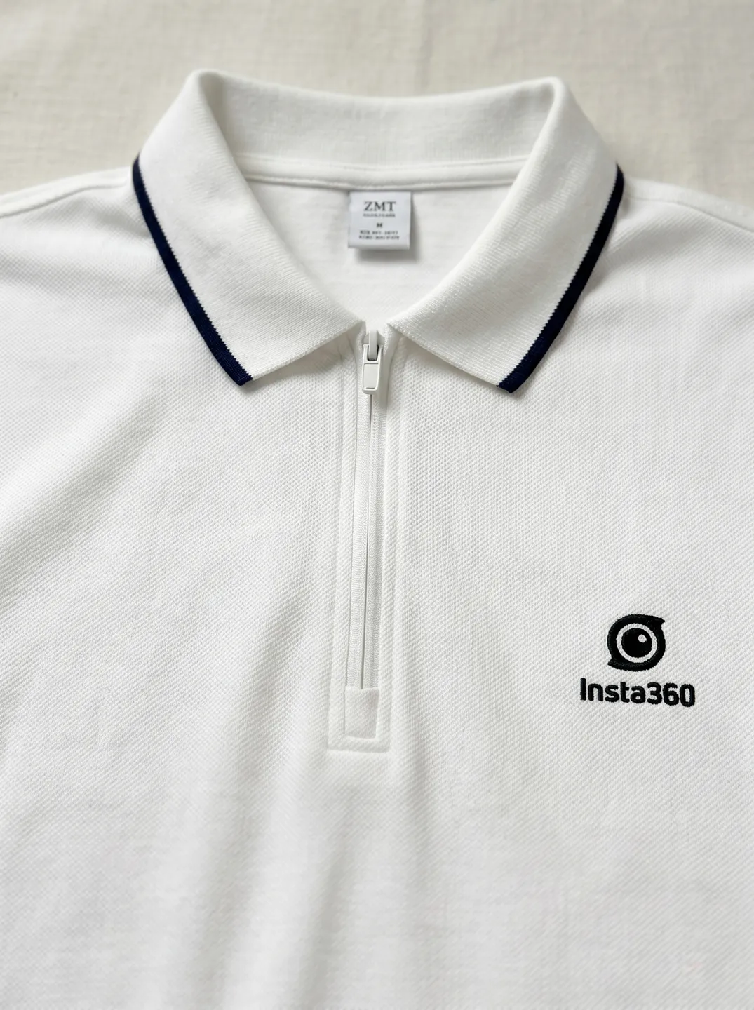 White Zip-Neck Polo Shirt · Logo and design details · PM-C-078 / 3