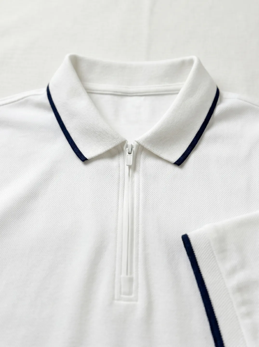 White Zip-Neck Polo Shirt · Logo and design details · PM-C-078 / 5