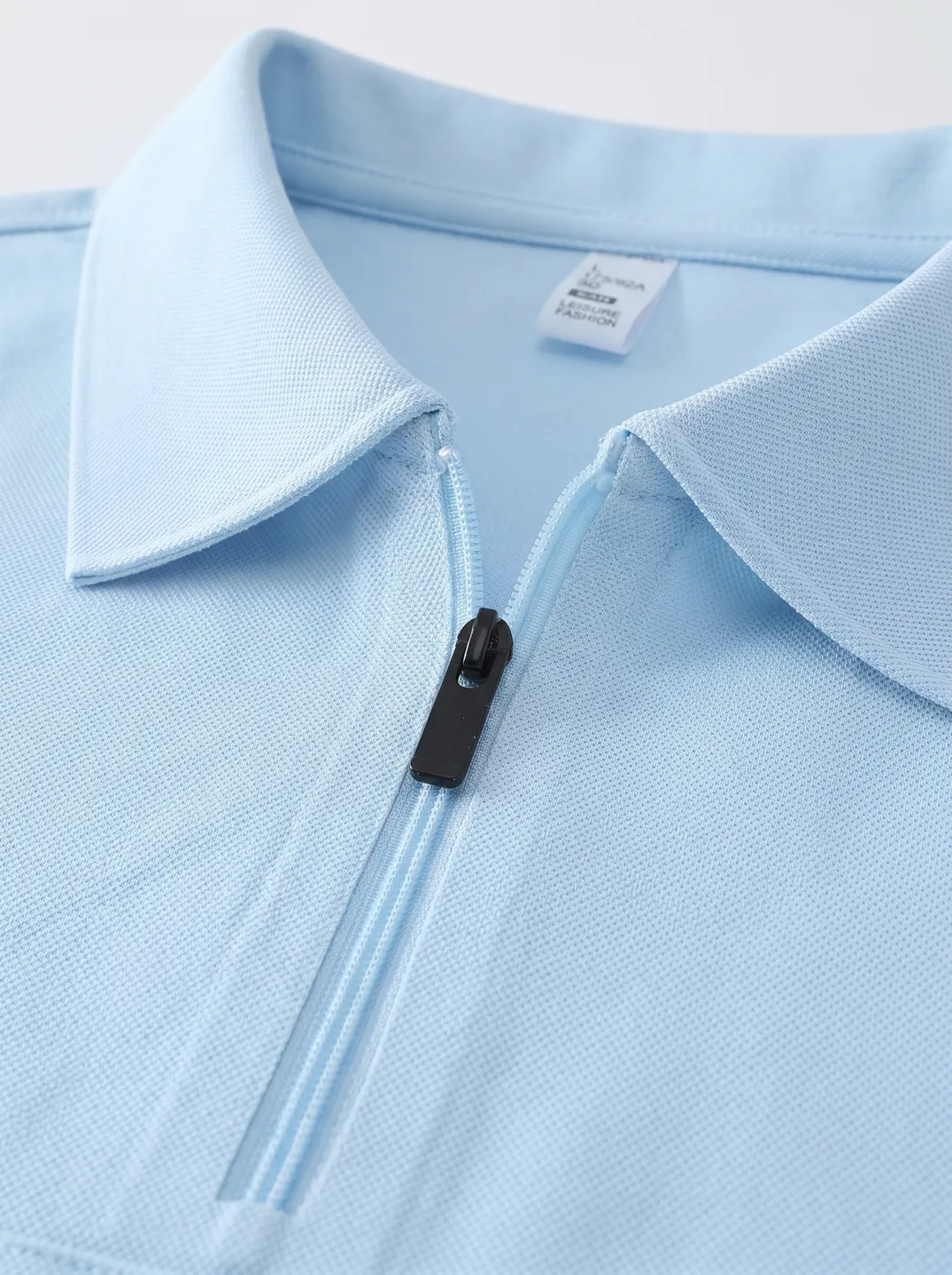 Light Blue Zip-Neck Polo Shirt · Logo and design details · PM-C-084 / 3