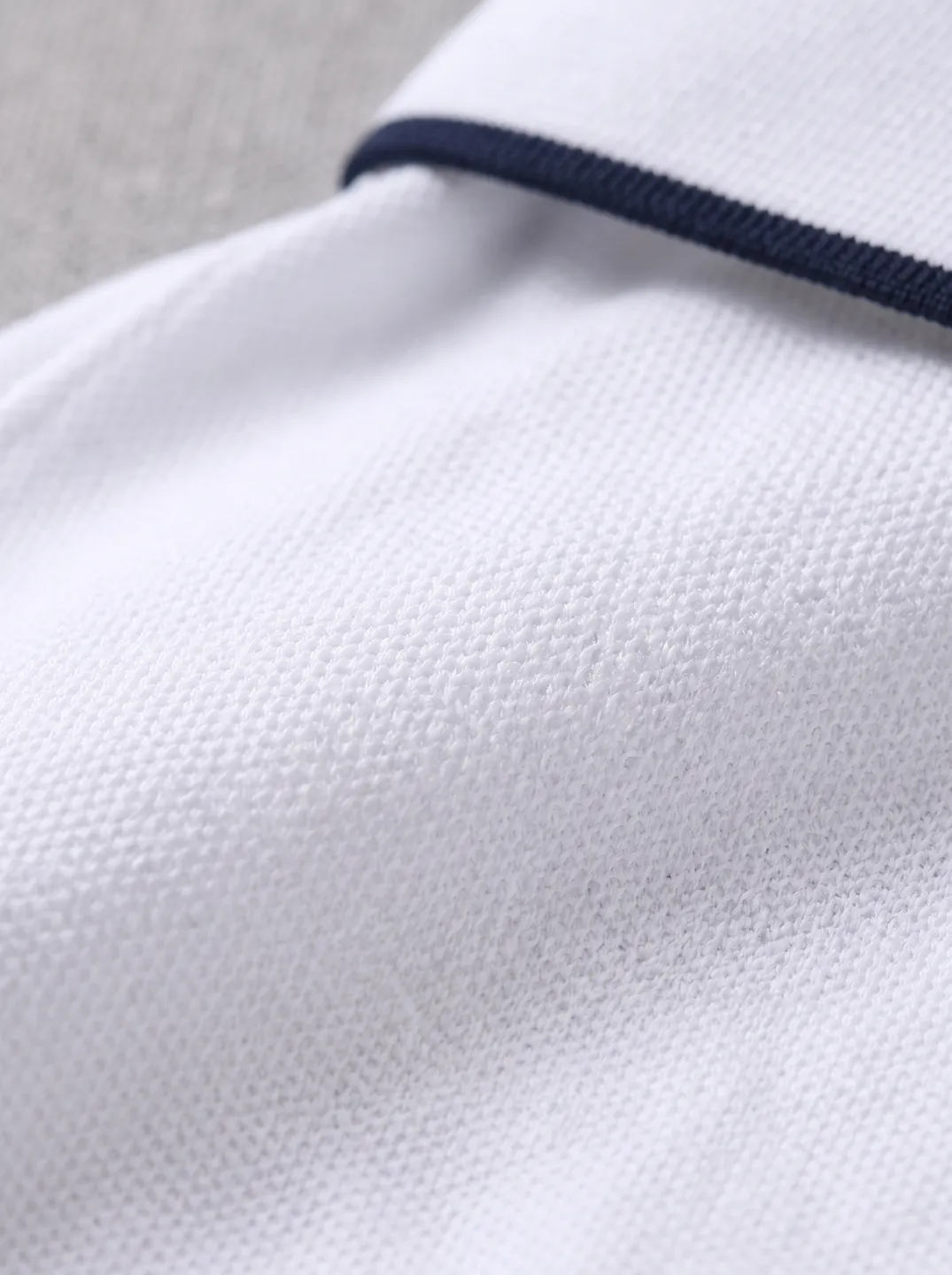 White Zip-Neck Polo Shirt · Logo and design details · PM-C-144 / 5
