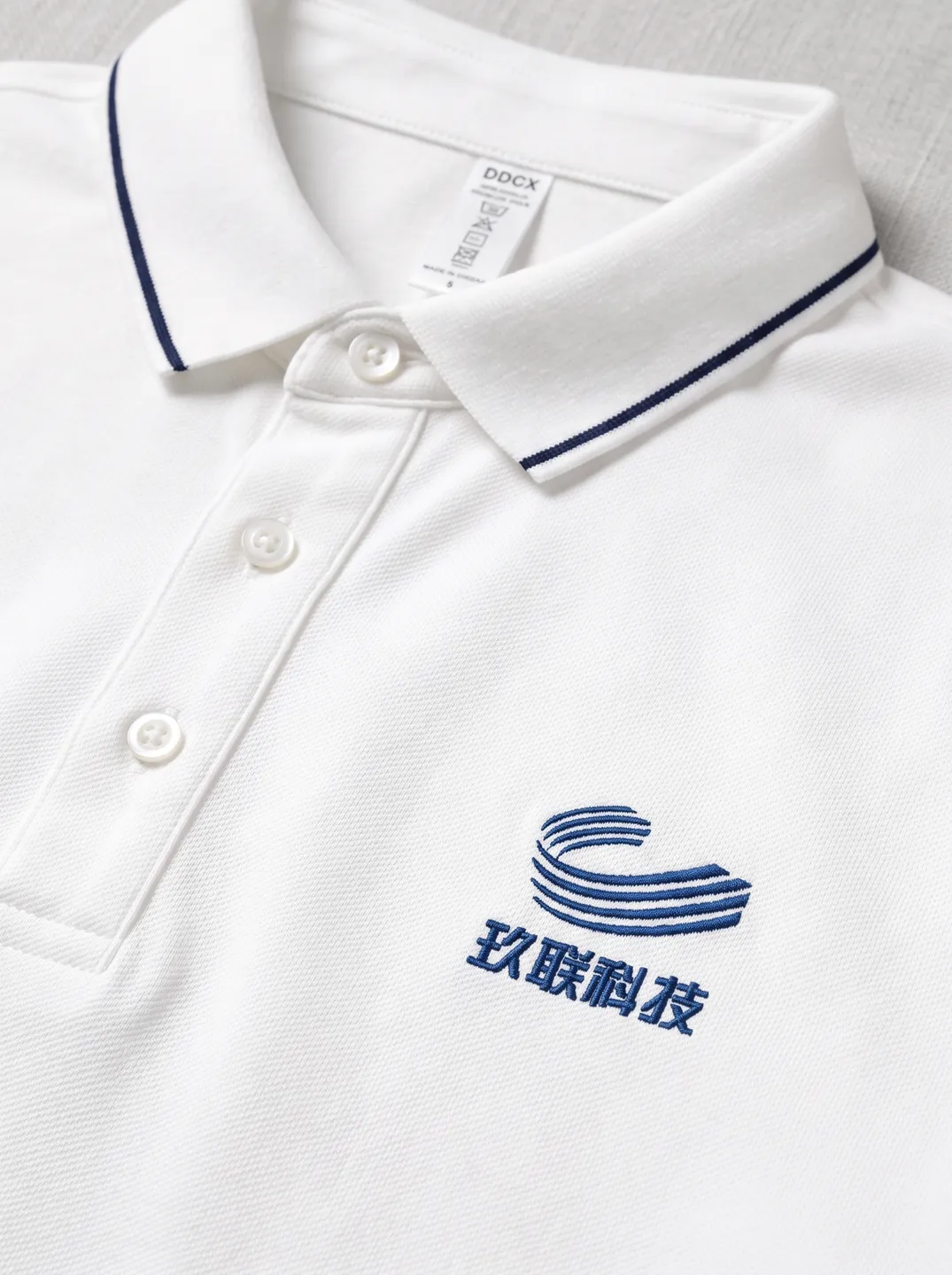 White Polo Shirt · Logo and design details · PM-C-148 / 3